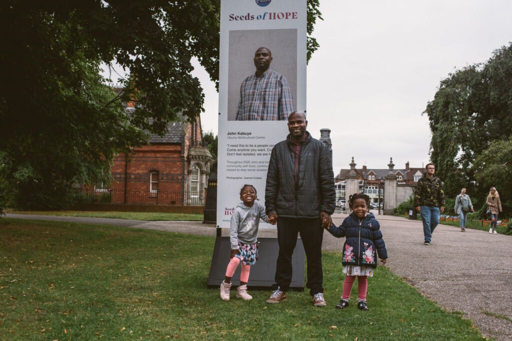John Kabuye with two of his children at the Seeds of Hope exhibition