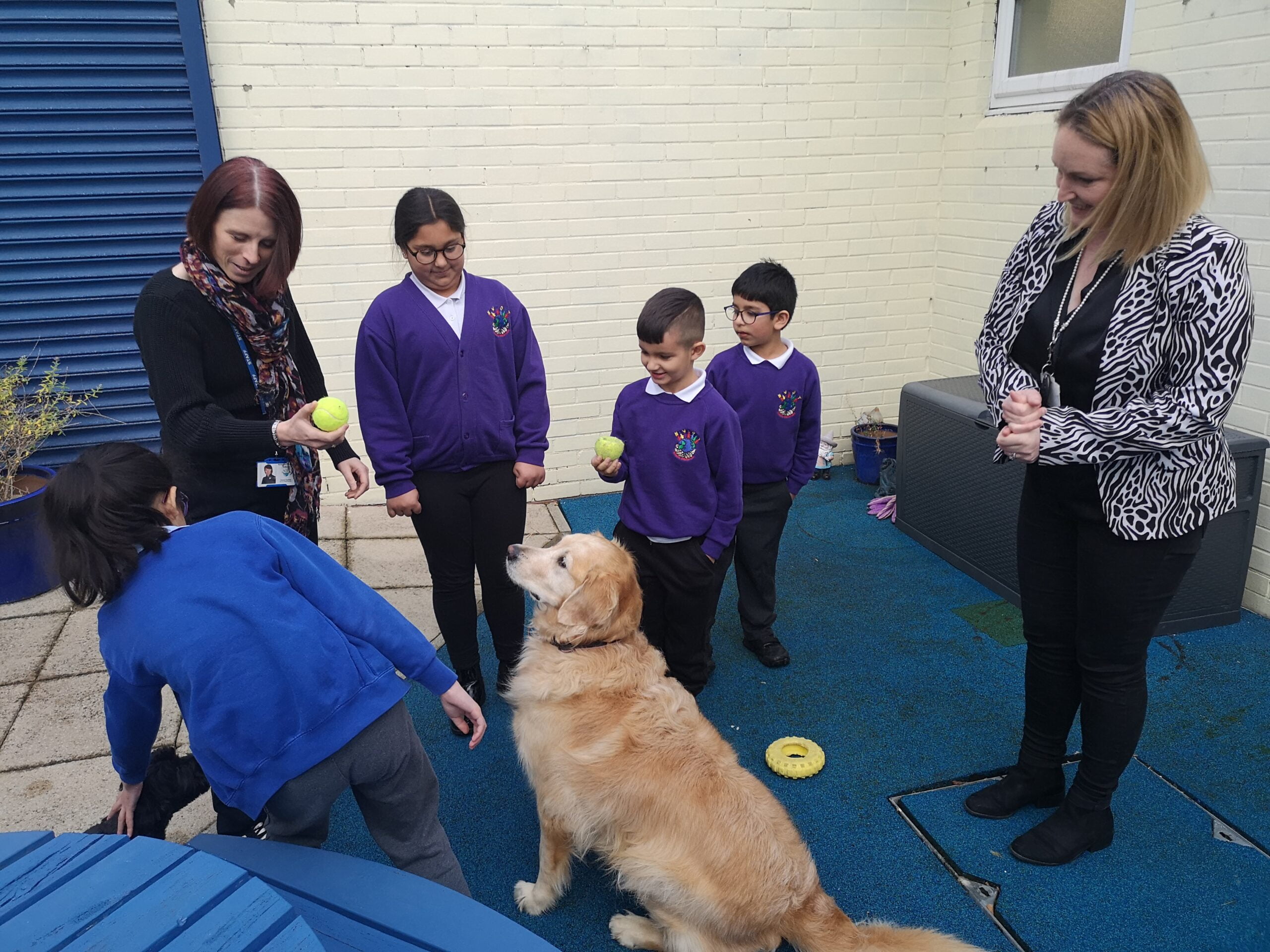Tricia Maxwell (right) and Stacey Carlisle with children and school dog Elsie from Newport School