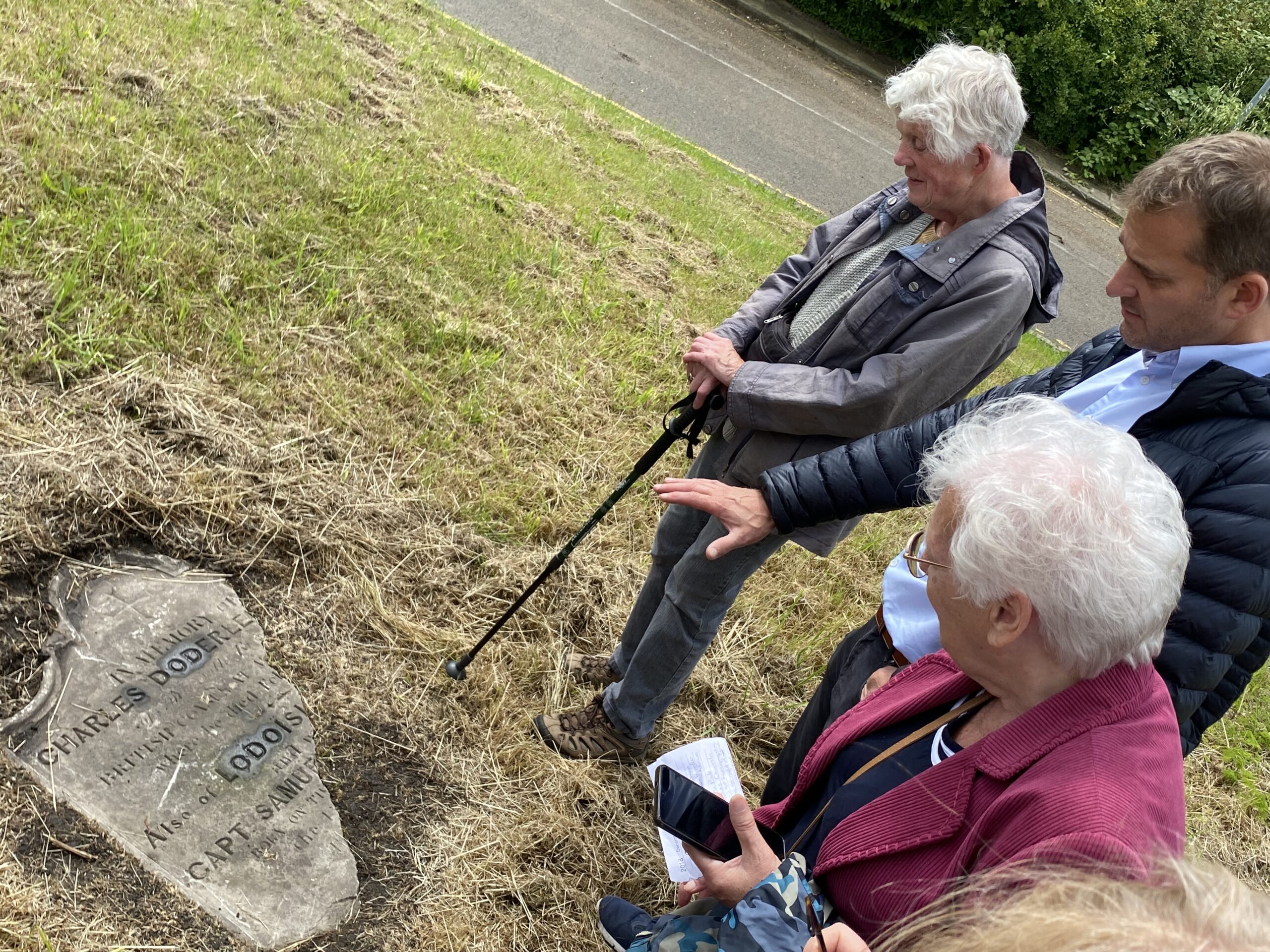 Visitors survey an uncovered headstone in what would have been the graveyard at St Hilda's Church